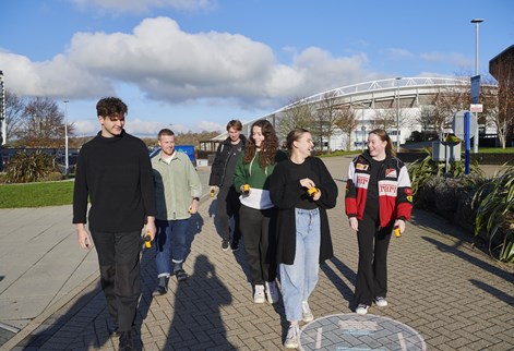 group of students walking through Falmer campus