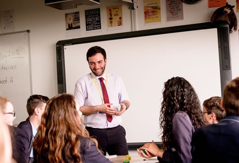 Trainee teaching standing in front of classroom with pupils