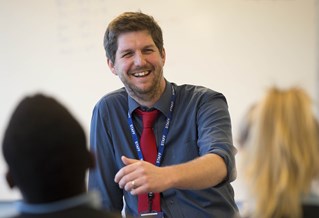 Male teacher in front of students