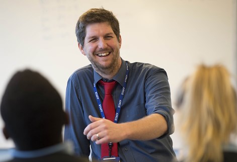 A teacher chatting to students 