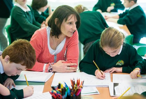 a female teacher in a primary classroom