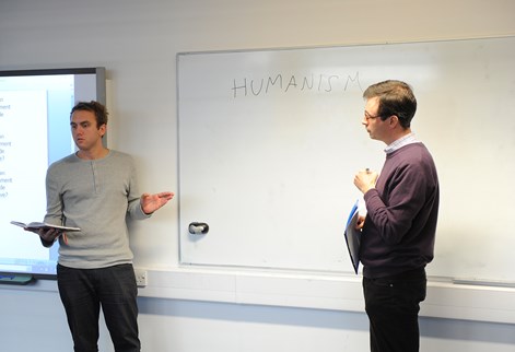 A teacher in front of a whiteboard in the classroom