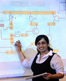 Student teacher giving a physics presentation in a classroom