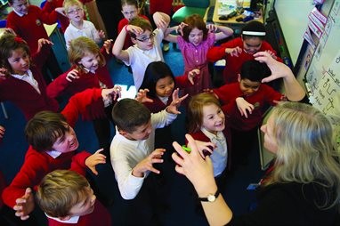 Primary school teacher teaching drama and trying to look scary in front of the pupils