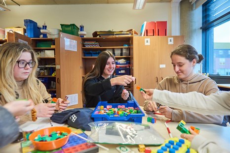 Group of teaching students using maths specialist equipment