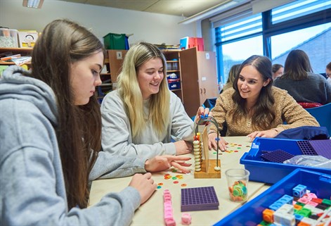 Group of teaching students with specialist maths equipment