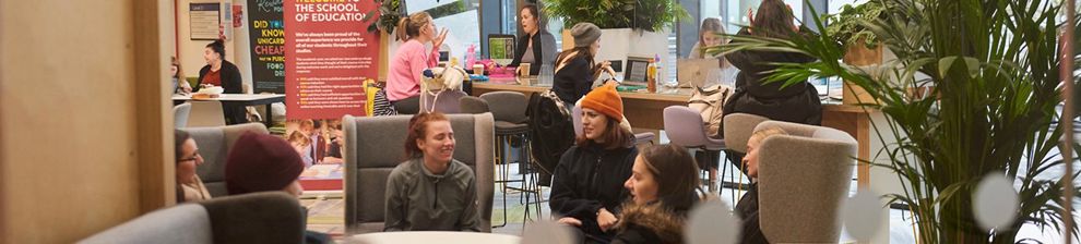 students sitting in Checkland building atrium