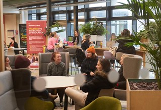 Students sitting in Checkland Building atrium