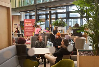 students sitting in Checkland building atrium
