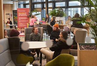 students sitting in Checkland building atrium