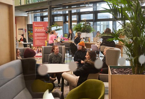 students sitting in Checkland building atrium