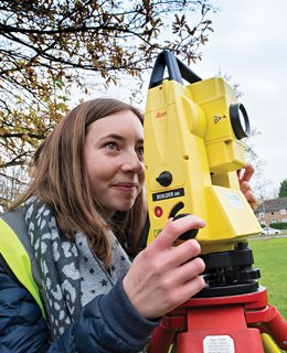 Civil engineering student with a theodolite