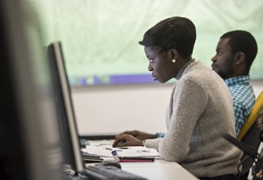 Two students looking at computer screens