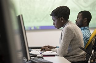 Two GIS students using computers