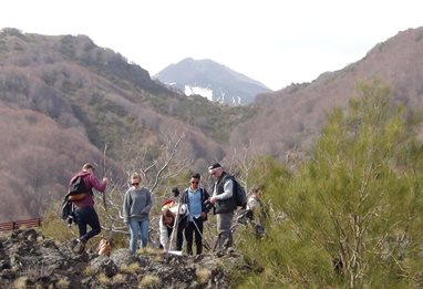 Lecturer with students on hillside in Sicily conducting fieldwork
