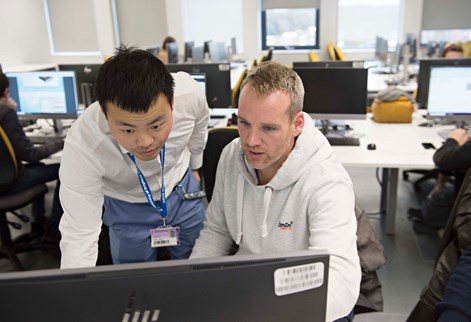 Student and lecturer studying computer diagrams