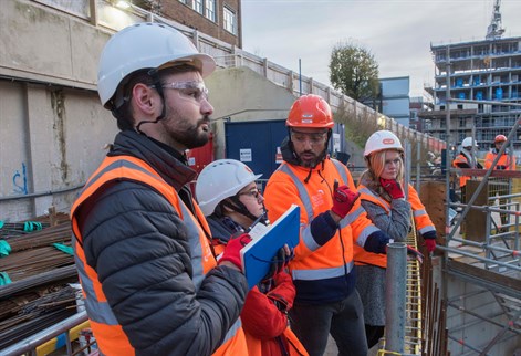 Students on a building site in high vis