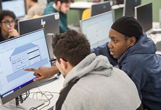 Students studying architectural diagrams on the computer