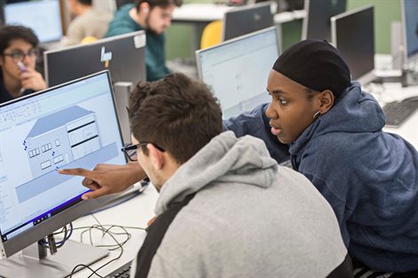 Students studying architectural diagrams on the computer