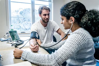 student taking another students blood pressure