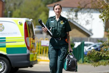 a paramedic walking with a clipboard