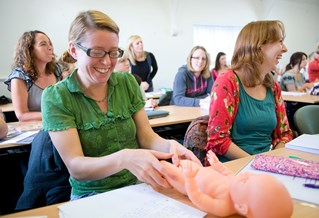 Child nursing student with a mannequin