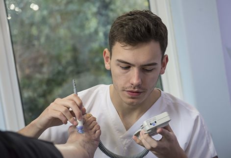 Podiatry student conducting a foot examination