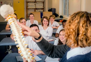 Lecturer with spine teaching students