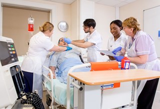 nursing students practising on a dummy