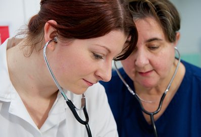 Two nurses wearing stethoscopes