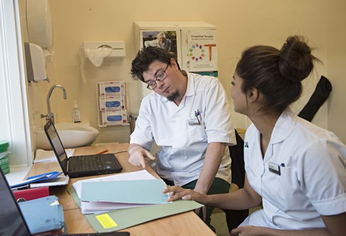 Occupational therapy students looking at patient notes in the Leaf Hospital