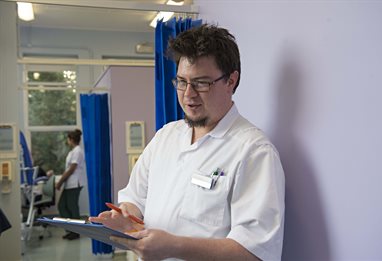 Student looking in on a patient at the podiatry clinic