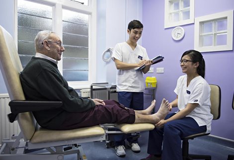 Podiatry students and elderly patient
