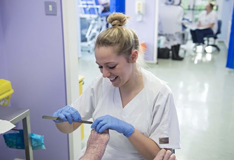 Student conducting a podiatry examination