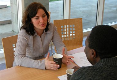 Students discussing their work over coffee