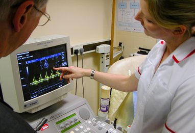 Nurse and doctor using diagnostic equipment