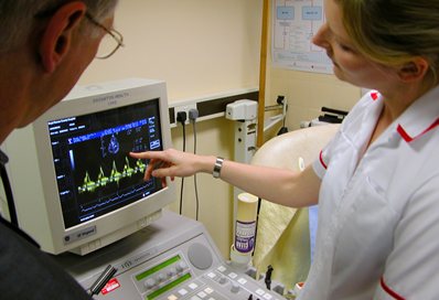 Nurse and doctor using diagnostic equipment