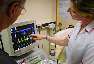 Nurse and doctor using diagnostic equipment