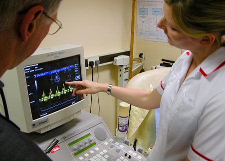 Nurse and doctor using diagnostic equipment