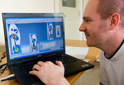 Podiatry student looking at results on a computer