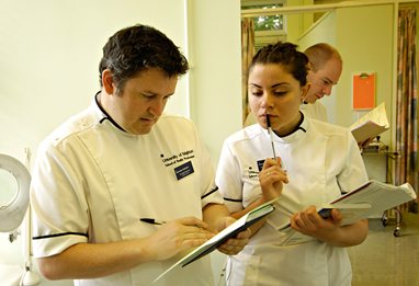 Podiatry students looking at results on a clipboard