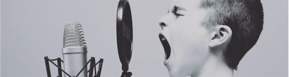 Young boy singing into microphone