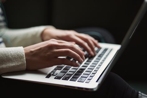 person typing on apple laptop