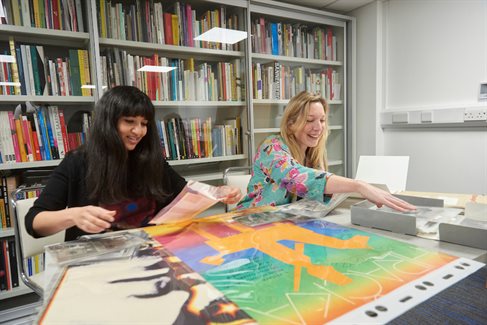 students work in the Design Archives, surrounded by shelves of catalogued items