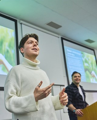 Two students presenting in a lecture