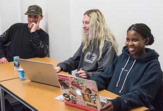 Three students with laptops