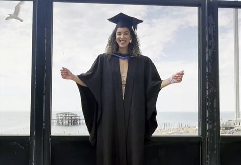 Izzy Womack in a graduation cap and gown