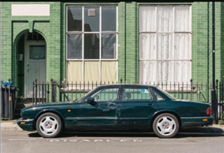 Battered old fashioned green car