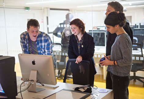 students working together around a computer