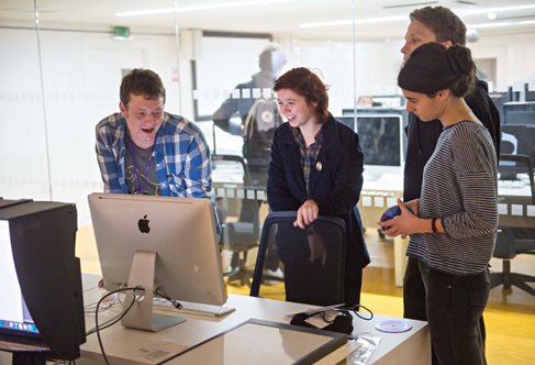 students working together around a computer